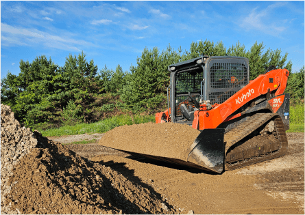 Dave Mann operating an orange Kubota SVL track loader