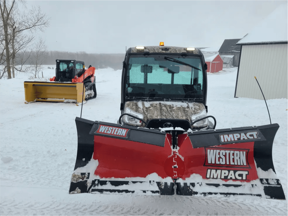 Western Impact snow plow mounted on a Kubota utility vehicle