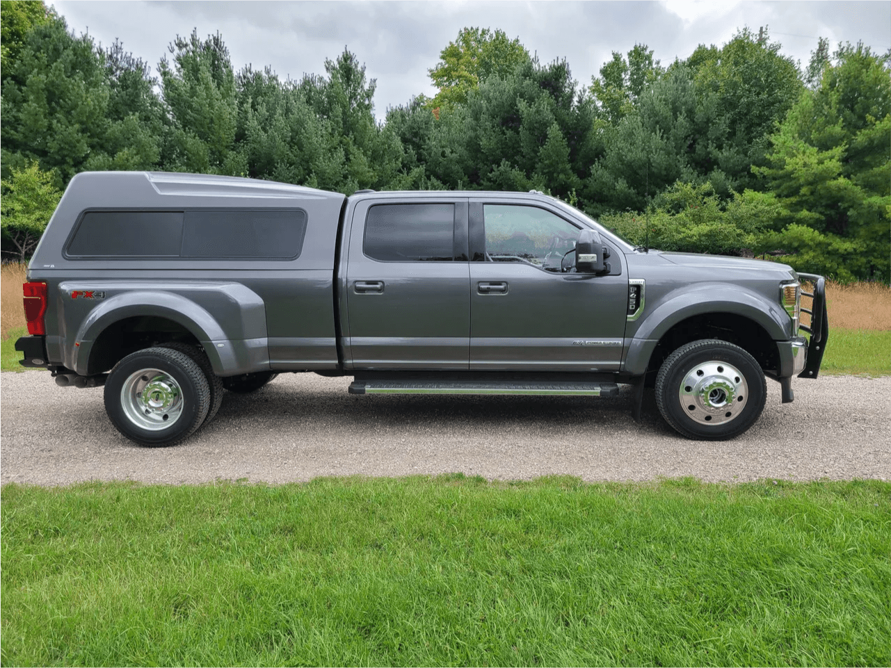 Gray Ford Super Duty dually with camper shell